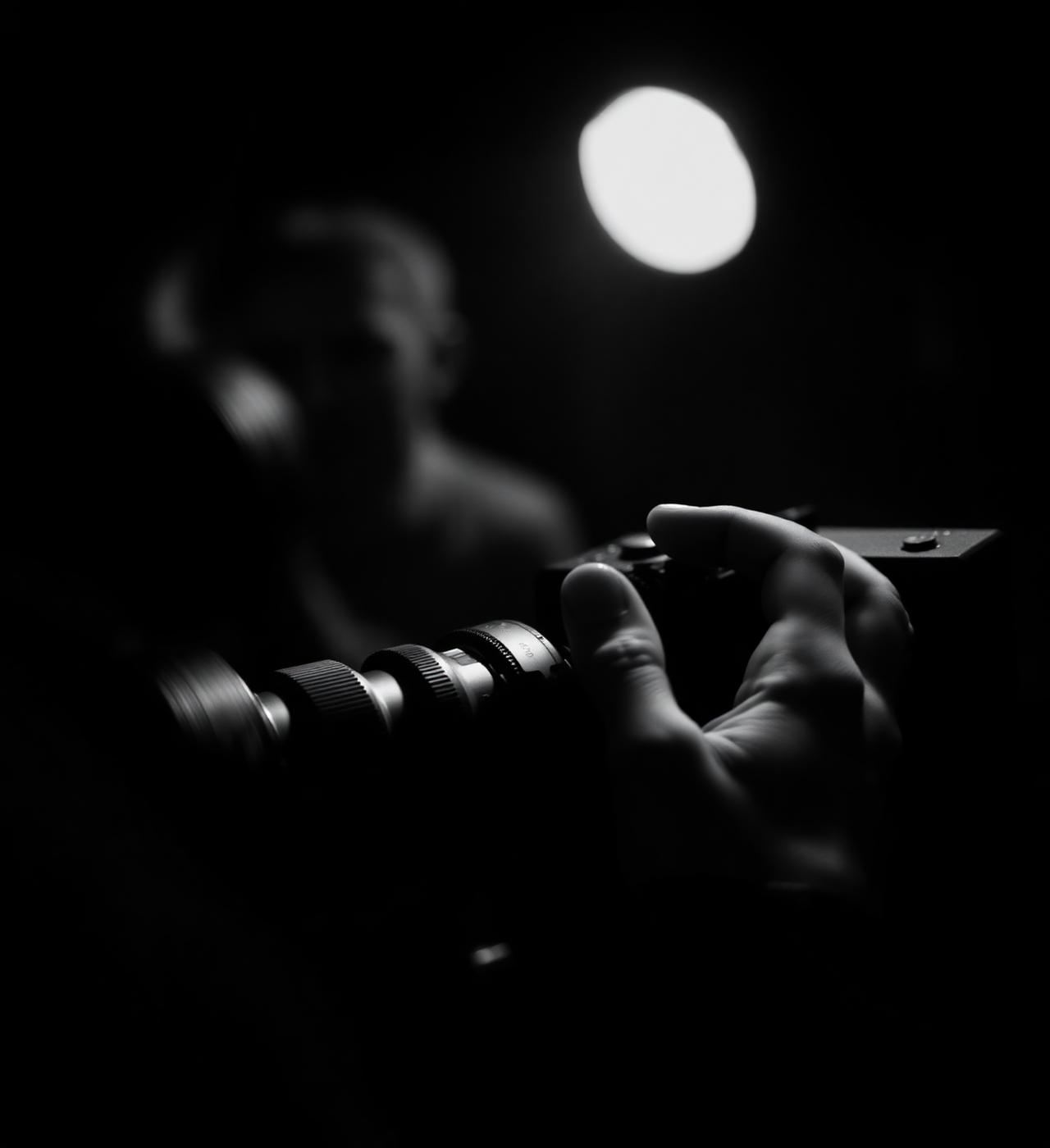 Cinematographer's hands on a camera focus ring